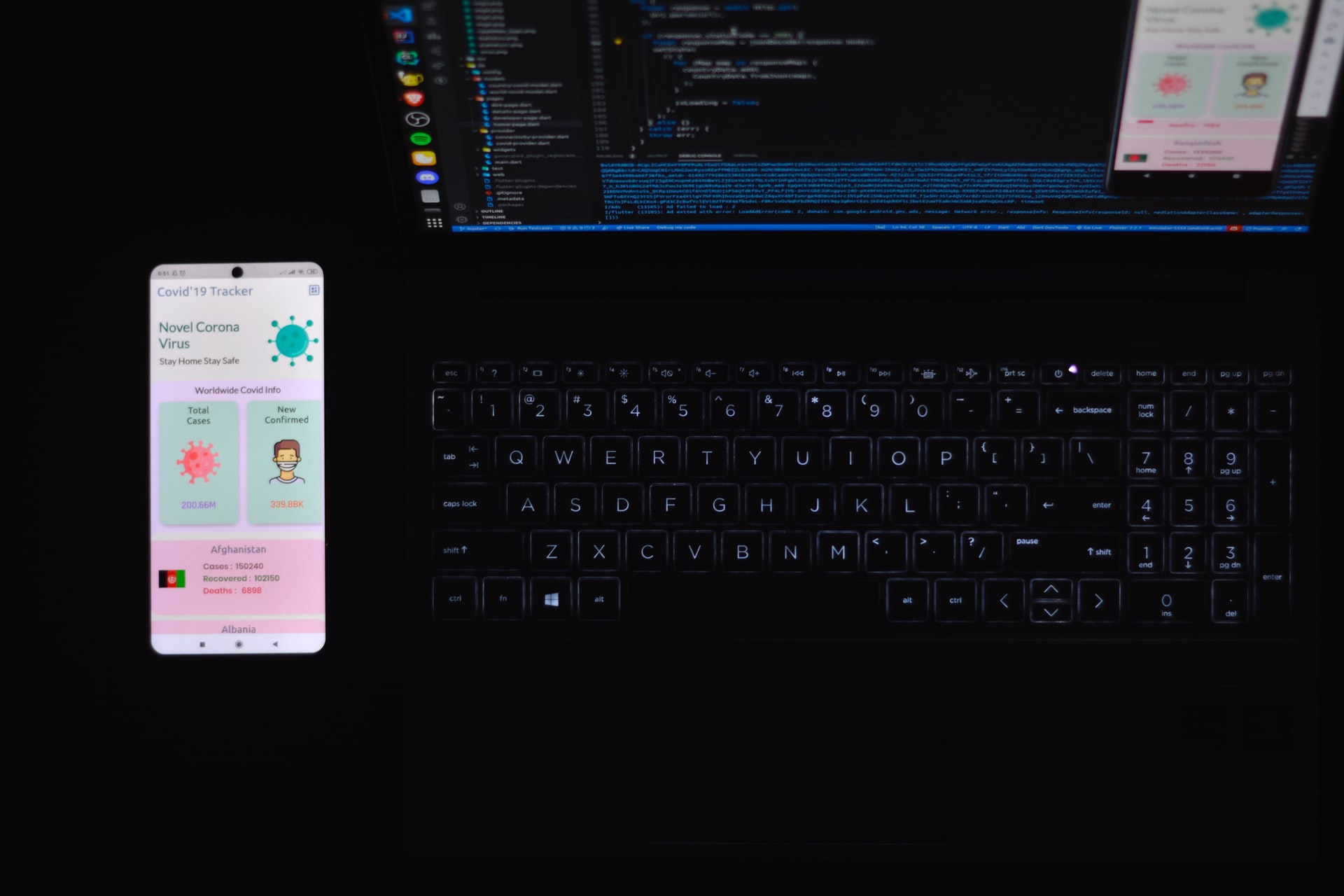 A phone and a laptop showing code
